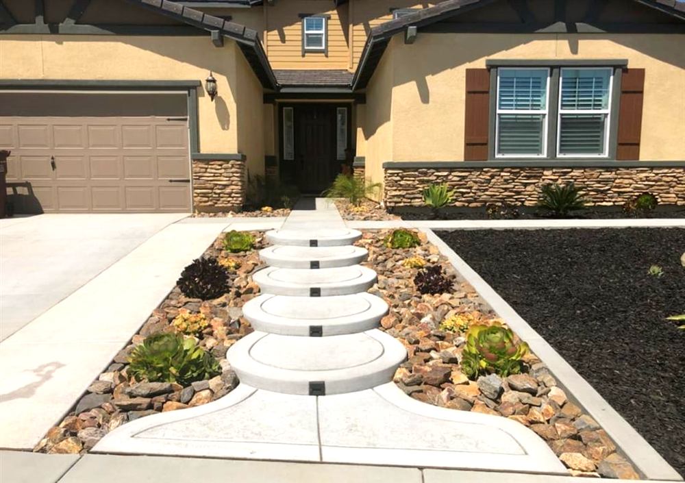 Front yard with curved concrete stepping-pad walkway and rock landscaping
